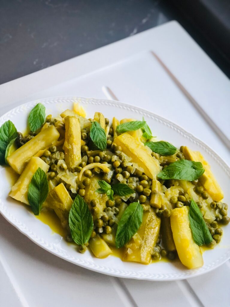 Delicious vegetarian dish featuring kohlrabi, peas and potatoes on a white plate