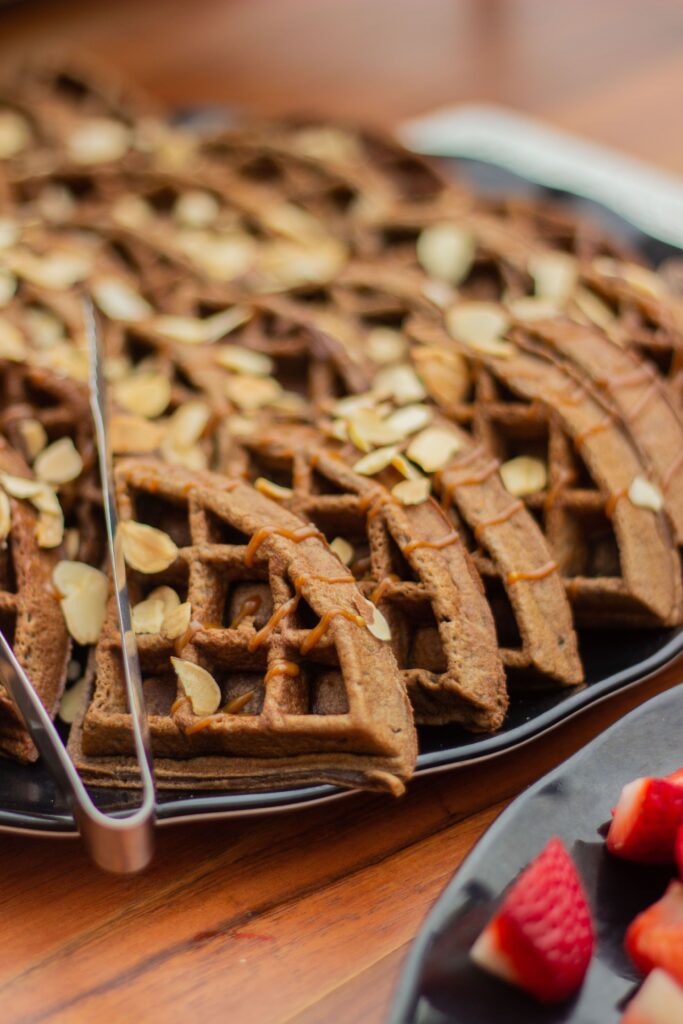 Close-up of homemade waffles topped with almond slices