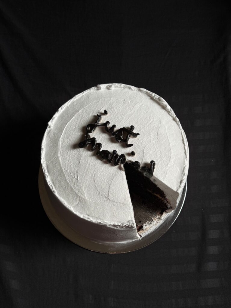 Rich chocolate zucchini cake topped with creamy white frosting